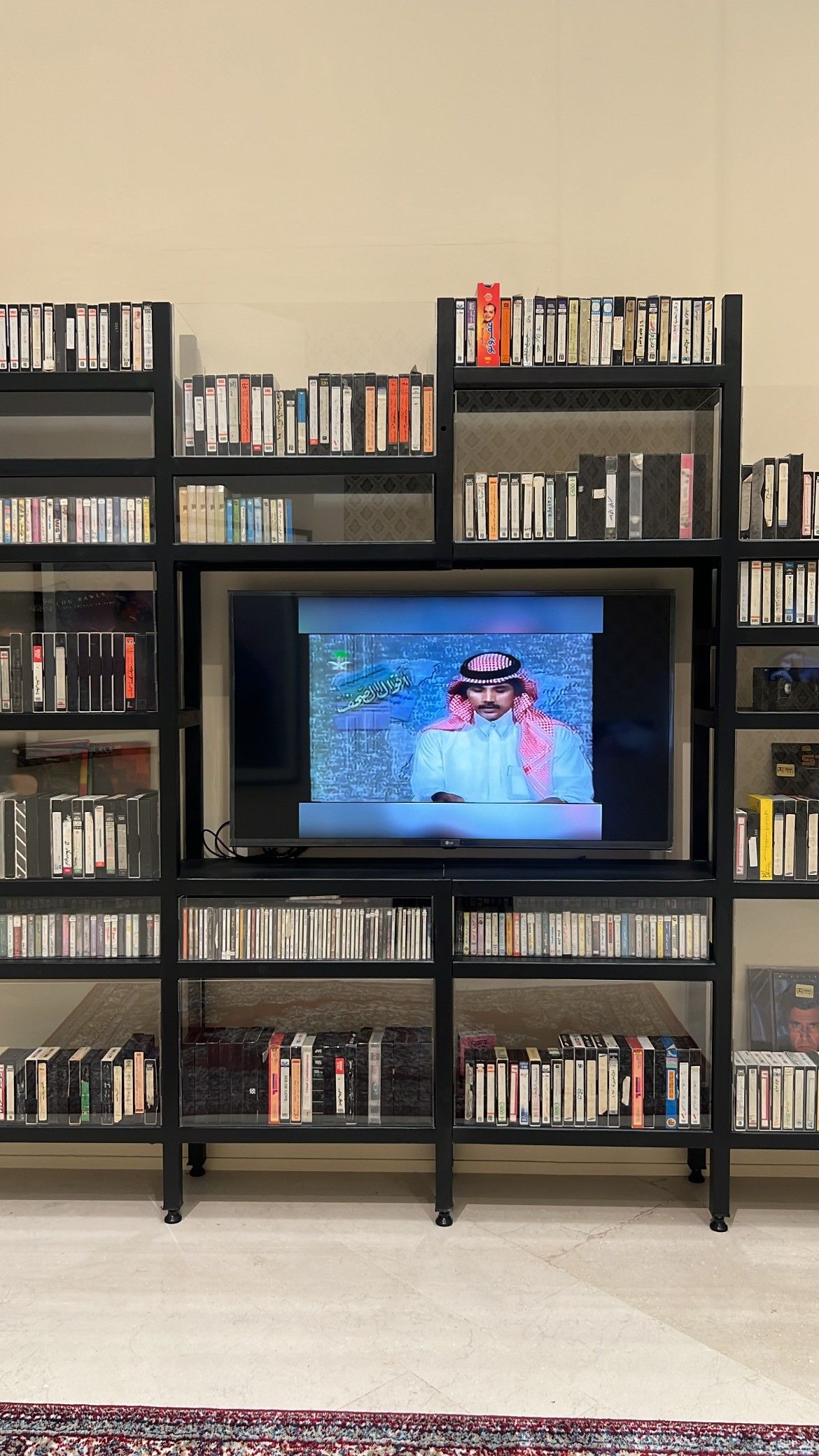 Nostalgia, 2025. Steel, black paint, VHS tapes, cassette tapes and videos from Saudi TV of the 1980s.A journey through Gulf culture, comprising video and cassette tapes the artist collected for over a decade, preserving records from private family gatherings through to national events. By Saad AlHowede. Courtesy of the Echoes of the Familiar exhibition.&nbsp;