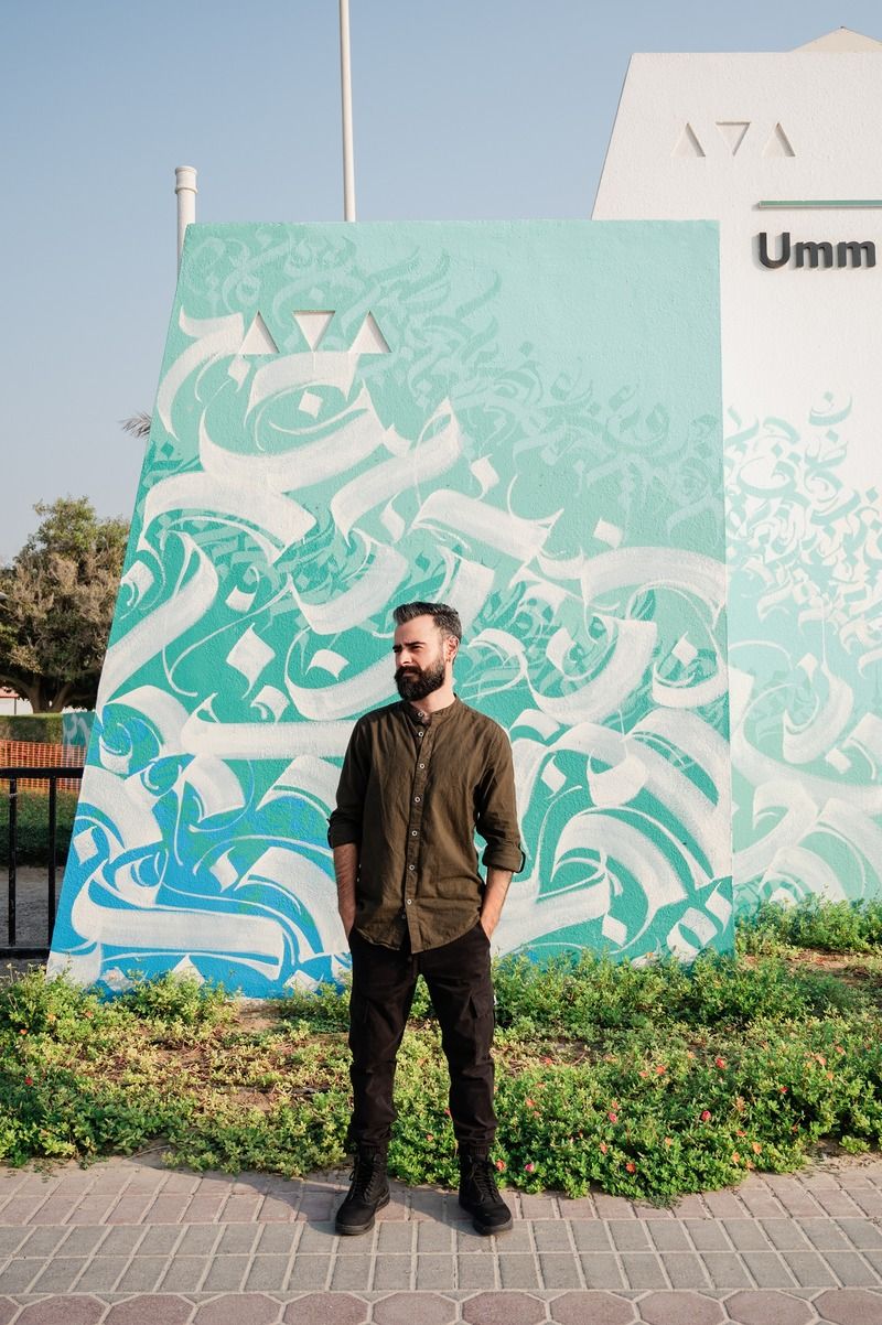 UAE-based Argentinian Yubran Gosne (aka Sanctum) with his mural titled ‘The Tide.’ Courtesy of the Dubai Culture and Arts Authority. 
