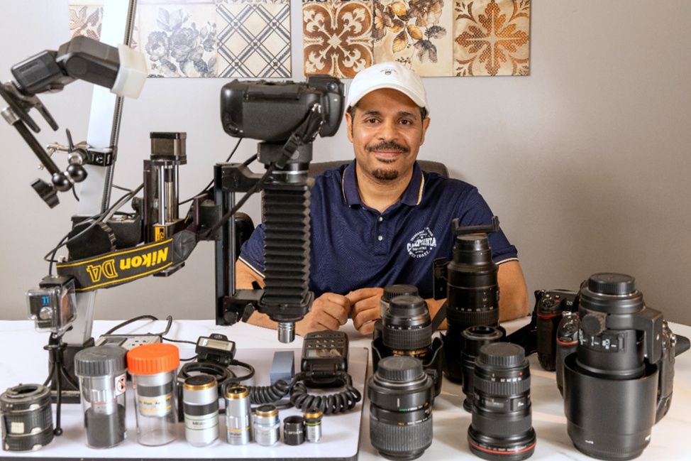 Award-winning macro-photographer Mishal Alryhan surrounded by his tools and lenses, 2025. Courtesy of Mishal Alryhan. 
