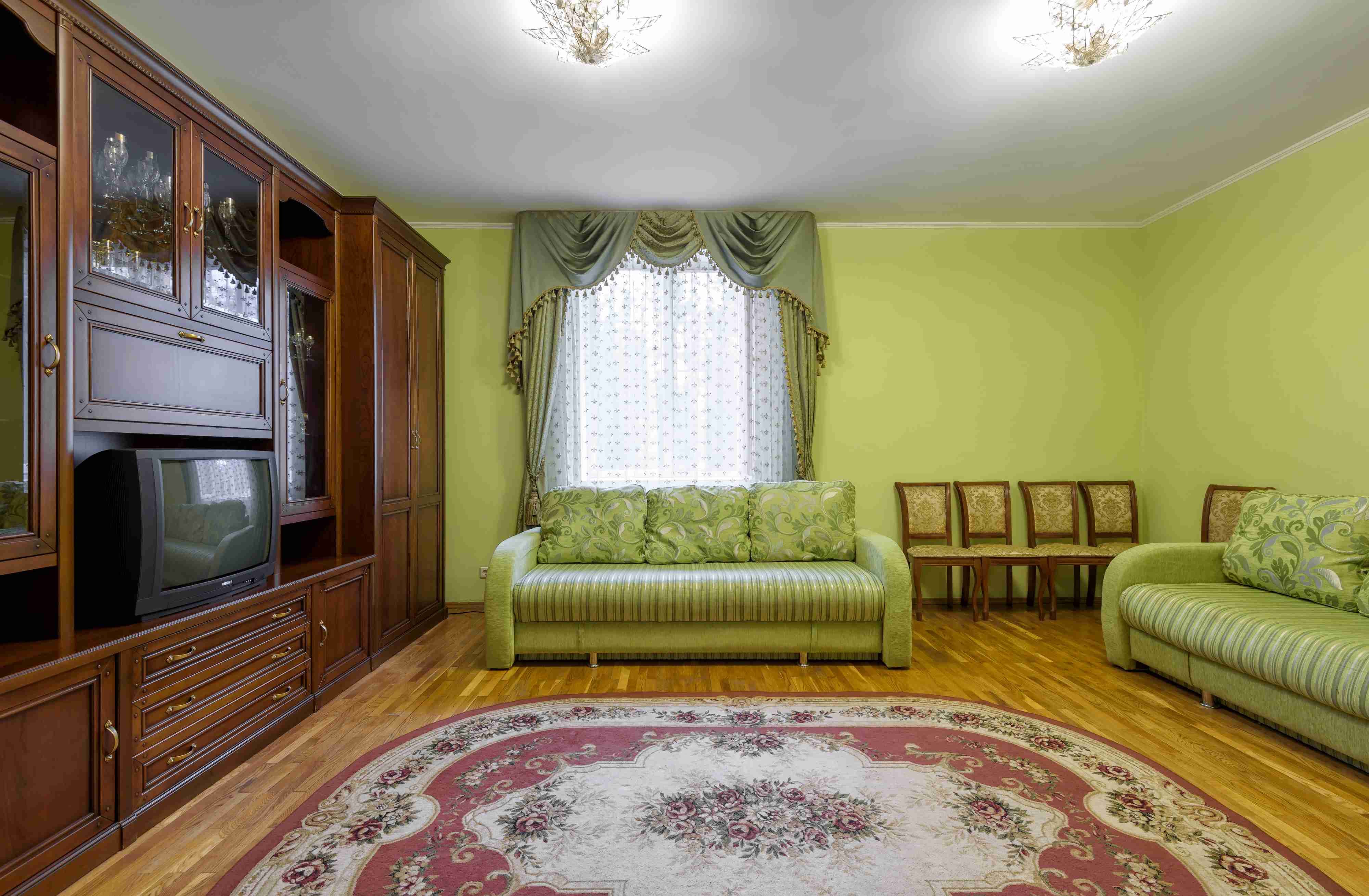 Room interior in Soviet style, living flat with vintage furniture, floor carpet and old TV.. Courtesy of Shuttetock.